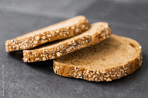 Bread, traditional sourdough bread cut into slices on a rustic wooden background