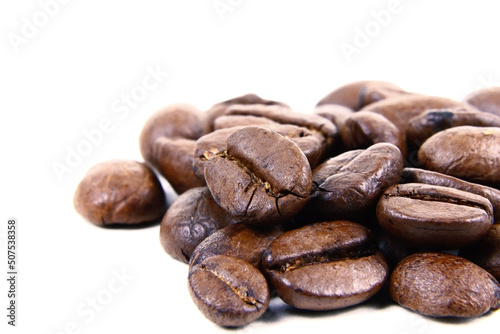 Roasted coffee beans isolated.Copy space. Heap of roasted coffee beans