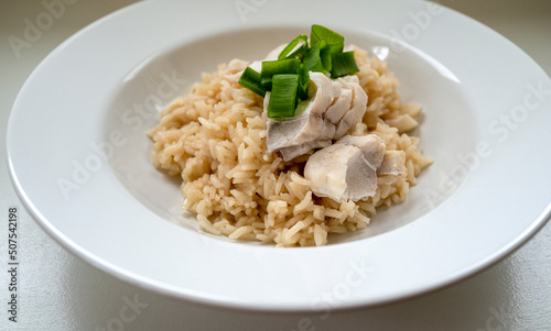 Tai Meshi Japanese special occasion dish with fish, rice, dashi, soy sauce, and ginger. Simplified weeknight meal served on a white flat bowl. Front angular view.