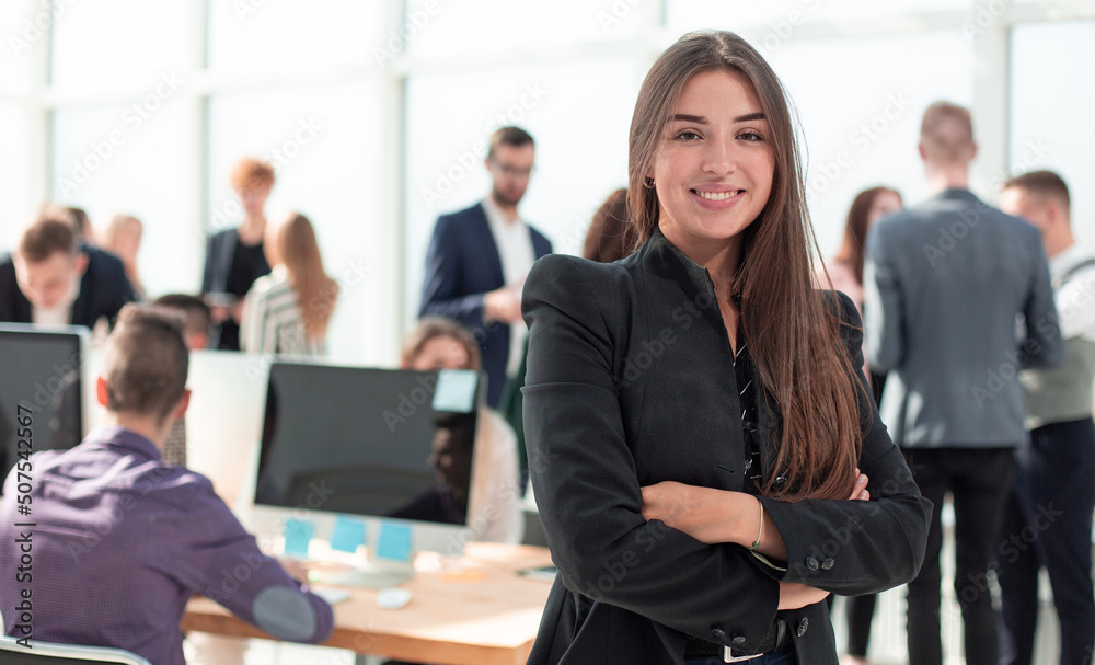 confident young business woman on the background of the office confident young business woman on the background of the office