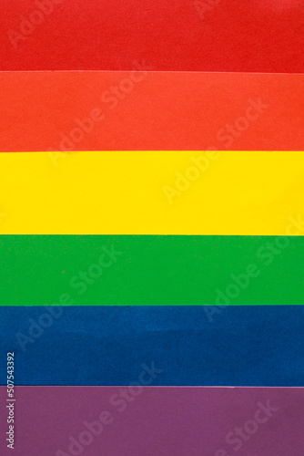 Rainbow LGBTQ or gay pride flag on colo paper texture. Abstract background for design.