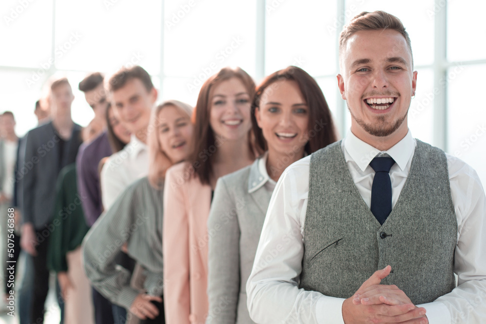 group of diverse young men standing one by one