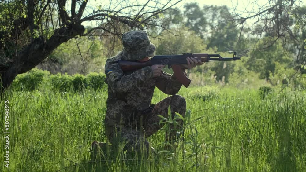Young Ukrainian female soldier in camouflage uniform with an assault ...