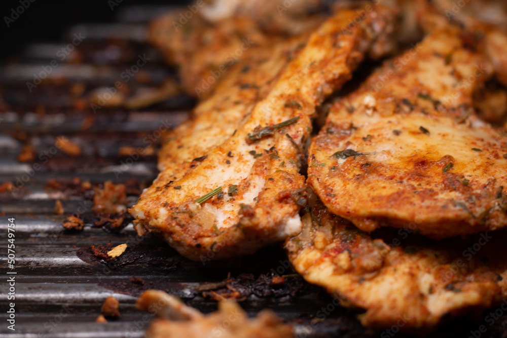 delicious grilled chicken fillet on the grill