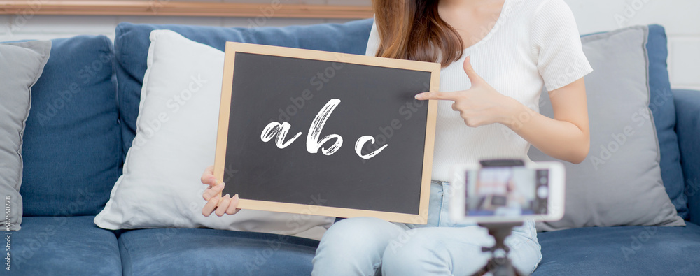 Φωτογραφία Young asian woman is teacher teaching language english with student for e-learning online at home, girl working and talking lesson in class with smartphone, stay home, new normal, education concept