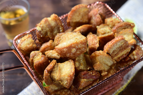 delicious fried pork rinds, typical Brazilian food served in a metal basket photo
