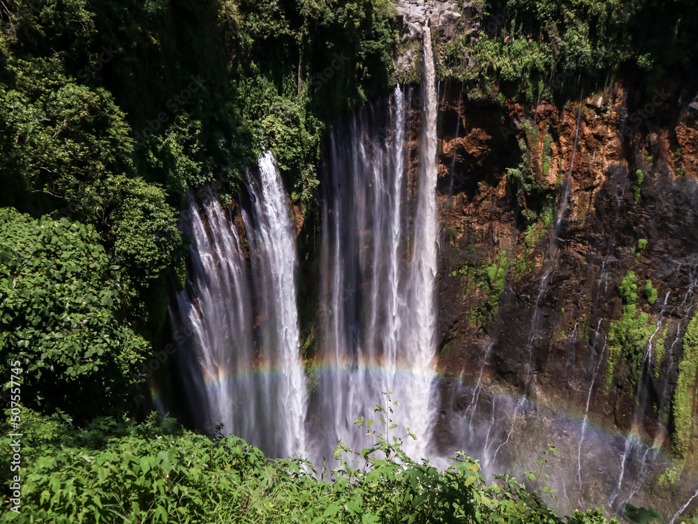 waterfall in the middle of the forest and rainbow. Lumajang, Indonesia.