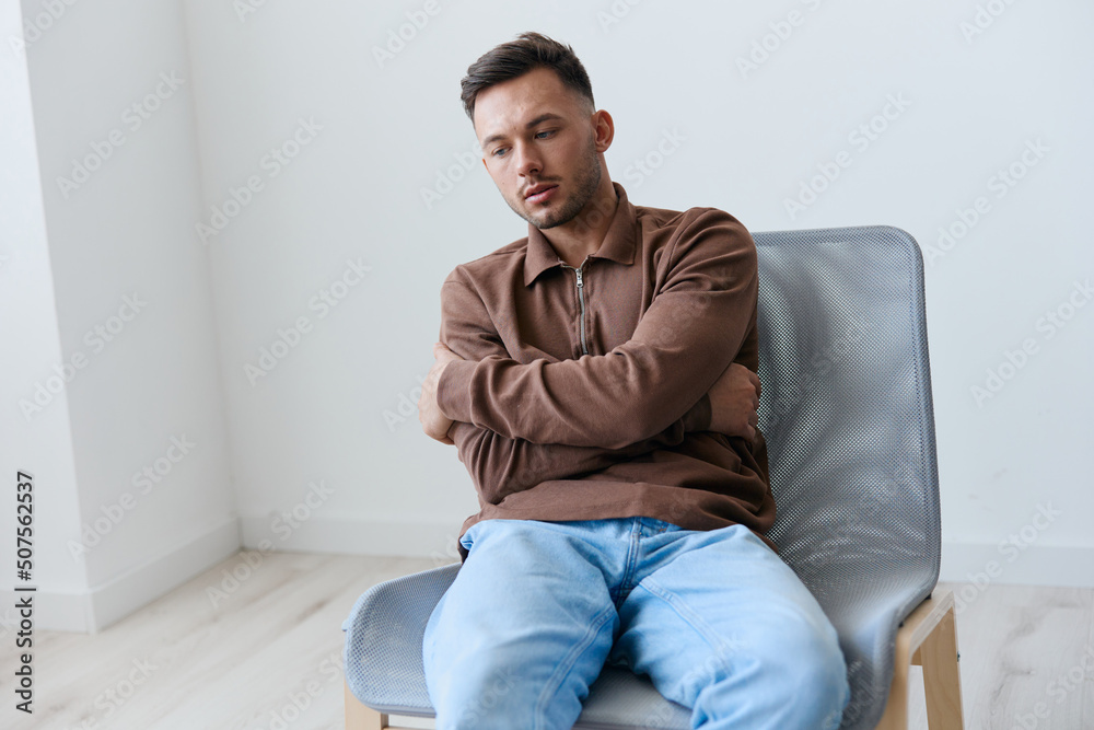 Sad frustrated suffering from bad relationship break up young man guy hugs himself looks aside have big mental problem psychological trauma after family conflict think about life's meaning. Copy space