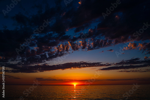 beautiful seascape during sunset, clouds over the sea during sunset