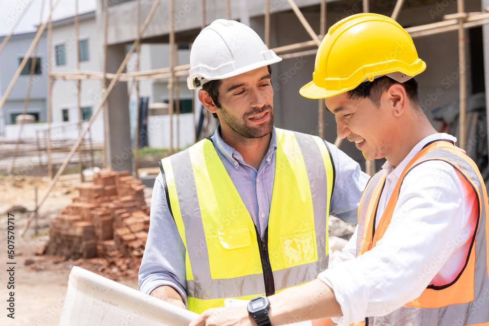 Two civil engineers man inspecting  construction of house in village that they responsible for outdoors for construction of residential houses to be in accordance with standards and strong