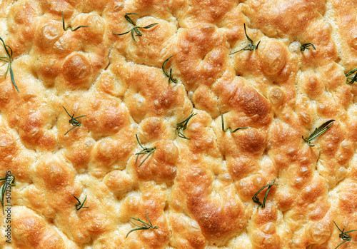 Homemade rosemary focaccia bread, above view, close up.