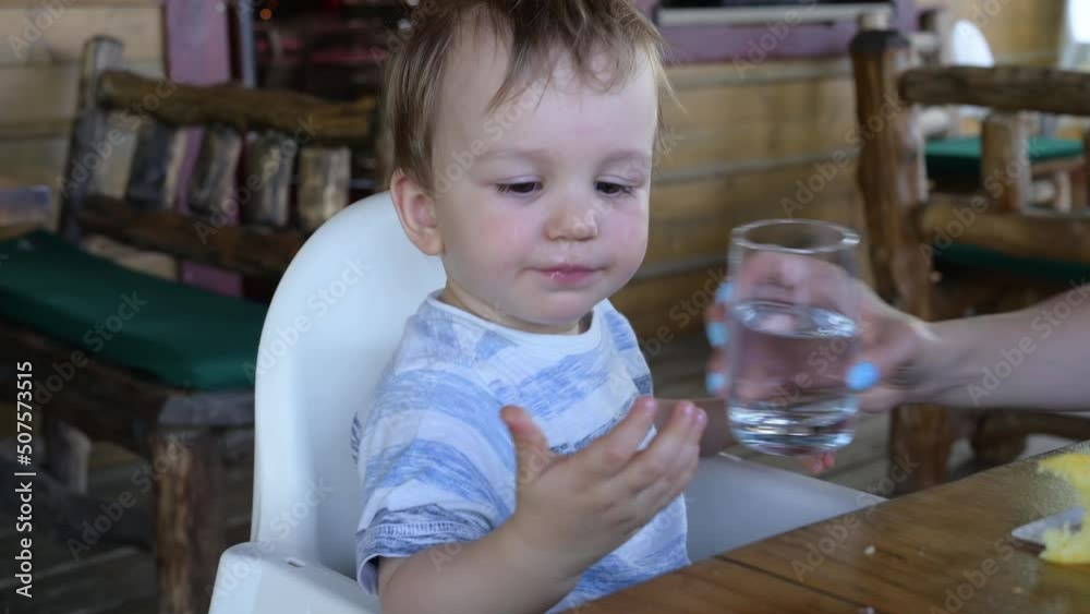 Cute little boy drinking water from glass Cute little boy drinking water from glass