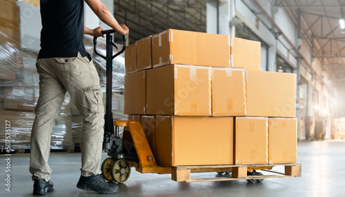Workers Unloading Packaging Boxes on Pallets in The Warehouse. Cartons Cardboard Boxes. Shipping Warehouse. Delivery. Shipment Goods. Supply Chain. Distribution Warehouse Logistics Cargo Transport.	
