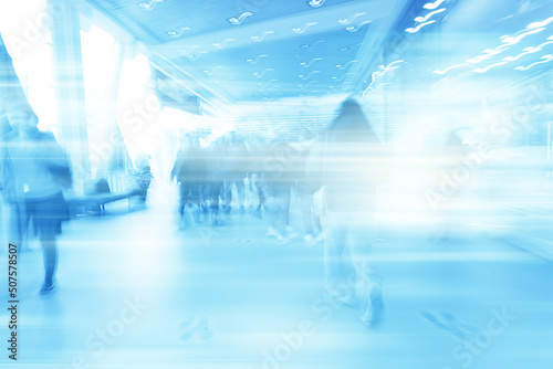 blue background blurred movement of people shopping mall
