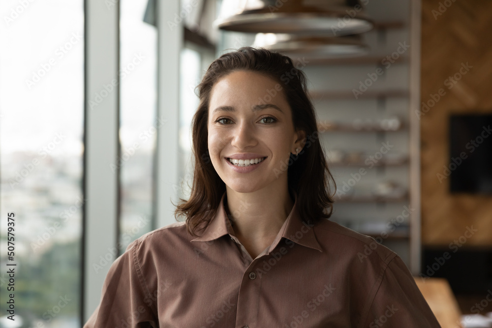 Headshot portrait of happy confident female leader, entrepreneur, self employed professional, office employee. Profile picture of young business woman looking at camera with toothy smile Headshot portrait of happy confident female leader, entrepreneur, self employed professional, office employee. Profile picture of young business woman looking at camera with toothy smile