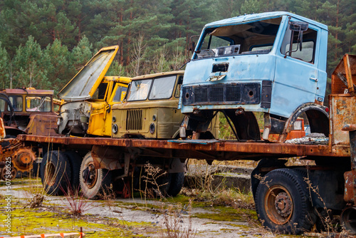 Old rusty abandoned damaged trucks in Chernobyl exclusion zone, Ukraine © olyasolodenko