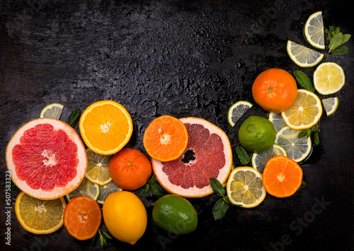 Citrus background. Fresh citrus fruits - Lemons  oranges  limes  grapefruits on wooden background.