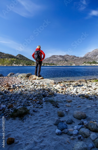 Female on Norwegian hiking adventure viewing fjord Europe