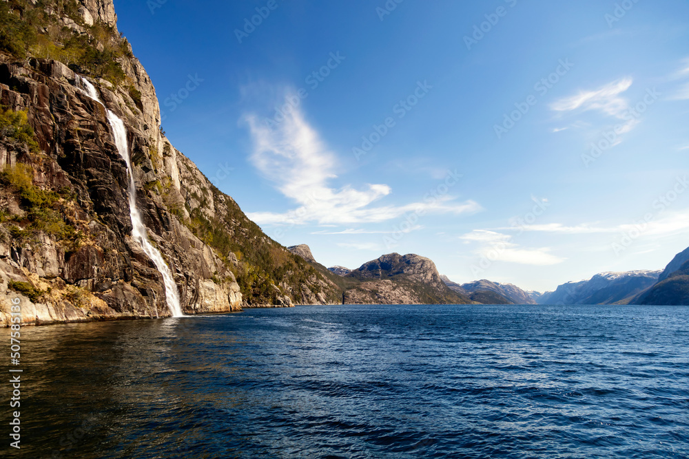 View of Norwegian waterfall cascading into Lysefjorden fjord View of Norwegian waterfall cascading into Lysefjorden fjord