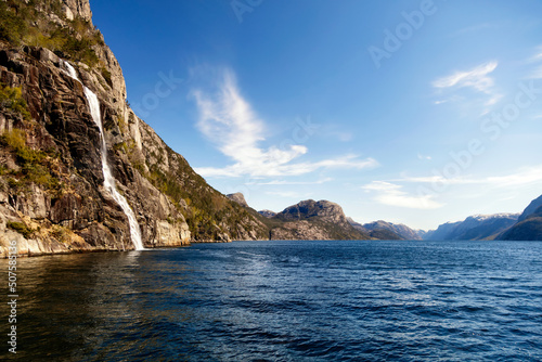 View of Norwegian waterfall cascading into Lysefjorden fjord