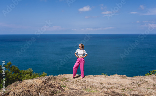 Young traveler woman at summer holiday vacation with beautiful mountains and seascapes
