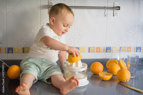 baby preparing orange juice