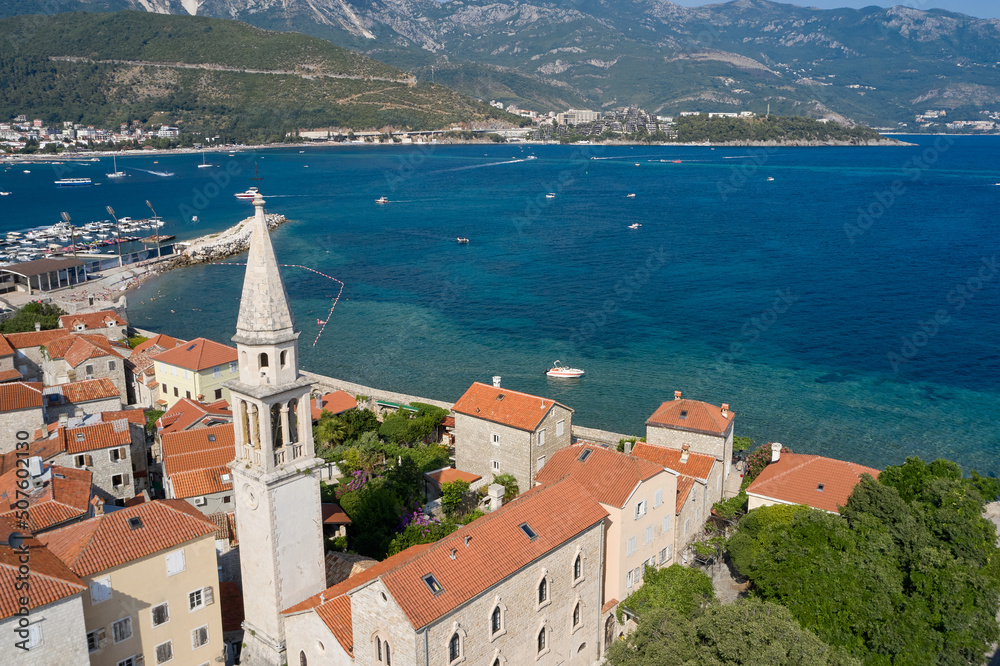 Old Town in Budva and the tower of the church on the background of the sea