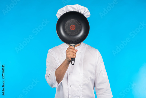 Chef cook covers his face w...