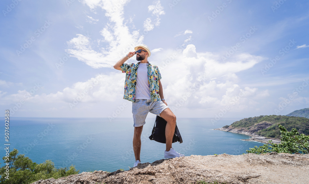 Young traveler man at summer holiday vacation with beautiful mountains and seascapes at background