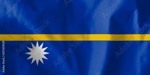 National flag of Nauru. On the flag of the Republic of Nauru: A yellow horizontal stripe divides the blue base of the flag into two equal parts.