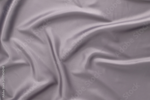 Closeup of gray silk fabric, wedding background, top view