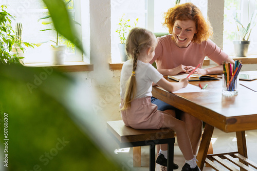 Professional female therapist communicate with child during extracurricular activities. Drawing, counting and social adaptation. Concept of support, studying, childhood,