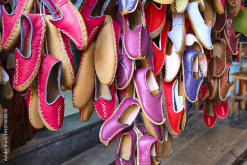 Traditional colorful leather shoes call as "Yemeni" in Turkey hanging on local bazaar. Selective Focus
