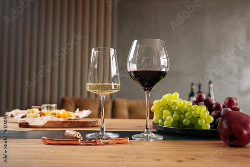 Assorted wine glasses with appetizers on wooden table
