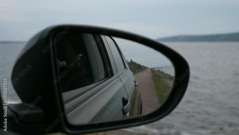 POV Car Side View Mirror. Vehicle Move on River Dam Along Reservoir. Overcast Autumn Winter Day. Slow motion 4K POV Car Side View Mirror. Vehicle Move on River Dam Along Reservoir. Overcast Autumn Winter Day. Slow motion 4K