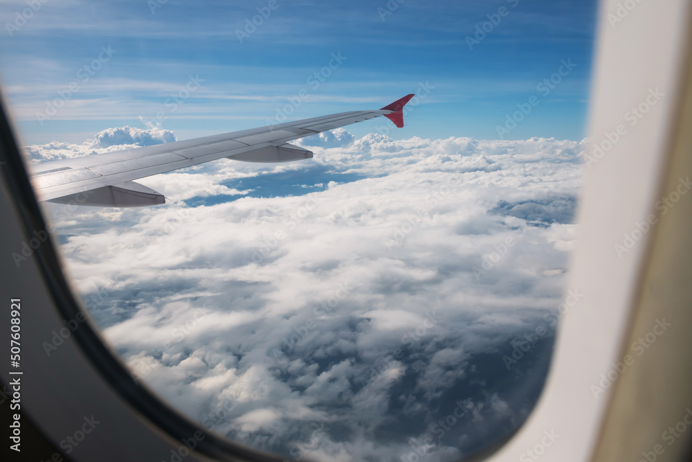 Fototapeta premium Cloudscape view from window of flying airplane