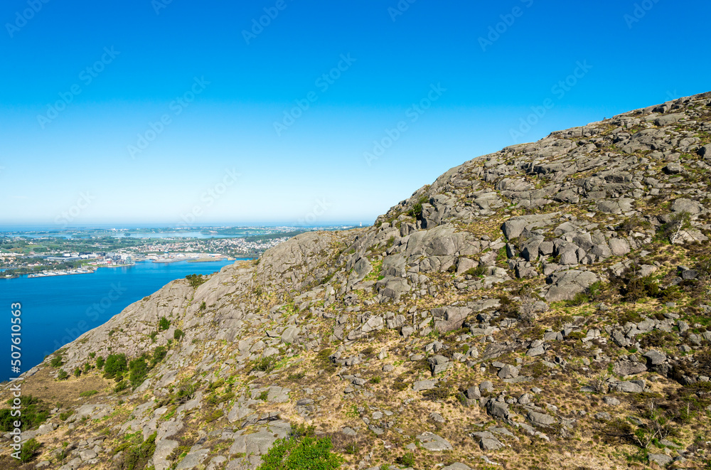 Scenic rocky slopes of Lifjel mountain with Gandsfjord and Stavanger on background, Sandnes, Norway, May 2018