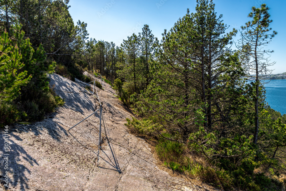 A metal cable along a trek route to Lifjel mountain for hikers to hold, Sandnes, Norway, May 2018