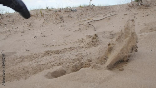 the jump of a Young Couple in the Sand. Slowmotion
