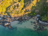 Downward aerial view of beach and crystal clear water