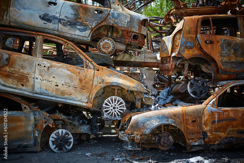 A lot of rusty burnt cars in Irpen, after being shot by the Russian military. Russia's war against Ukraine. Cemetery of destroyed cars of civilians who tried to evacuate from the war zone
