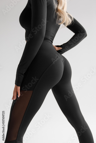 Fitness model in leggings with beautiful buttocks. Sporty booty