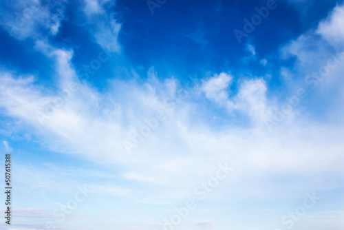 white clouds on a blue sky. nature background in morning light