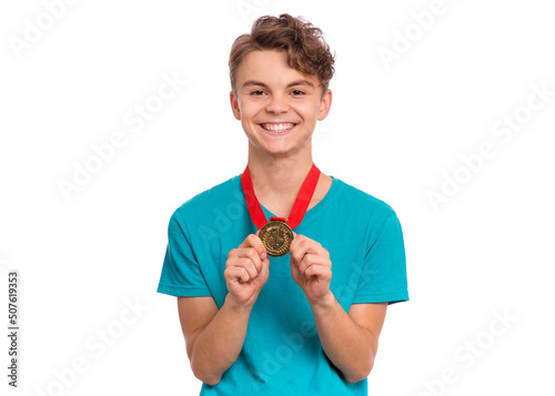 Happy winner. Portrait of Handsome Teen Boy Student holding gold Medal. Smiling child celebrating his success, isolated on white background. Back to School or sport concept