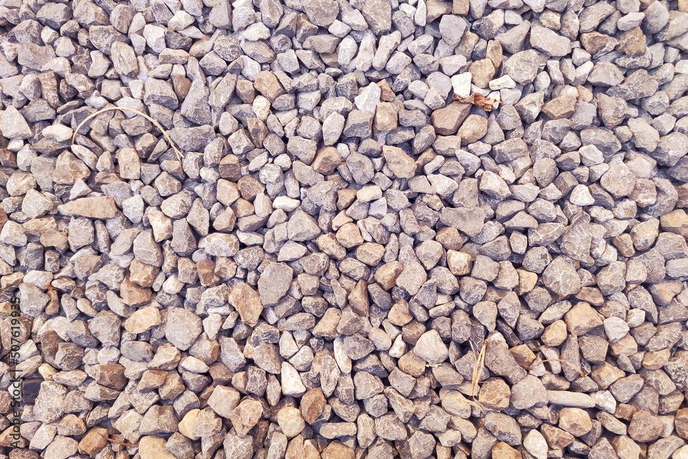 Small gravel road. Pebble background. Crushed stone texture. Gravel rock closeup Small gravel road. Pebble background. Crushed stone texture. Gravel rock closeup