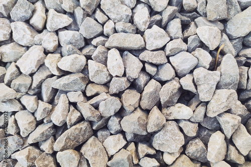 Small gravel road. Pebble background. Crushed stone texture. Gravel rock closeup