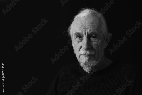 Konstfotografi Low key studio black and white front view of beautiful gray hair old man