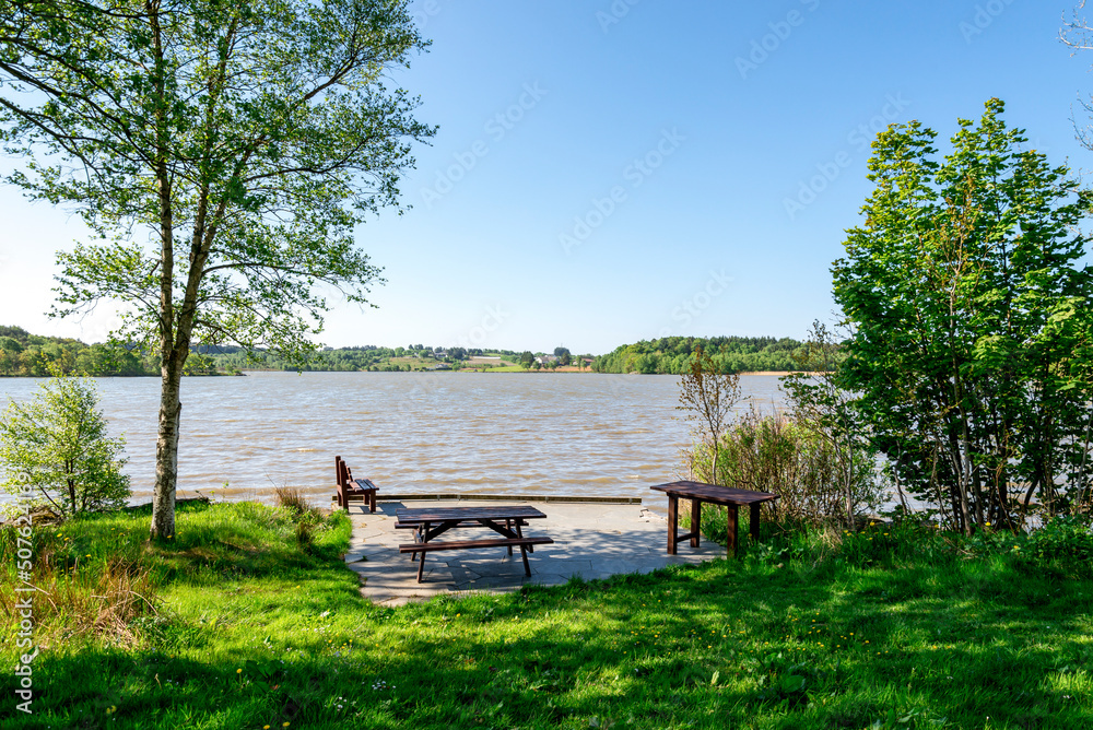 A picnic table and a bench at the shore of Halandsvatnet lake, Stavanger, Norway, May 2018