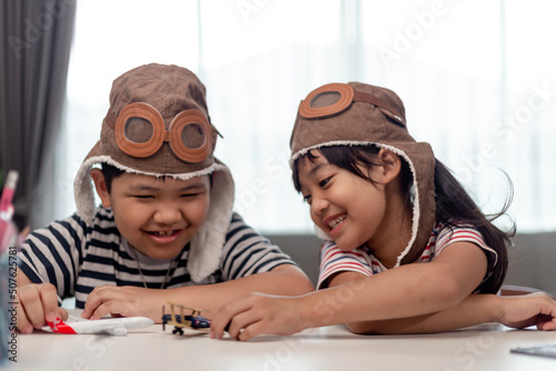 Two children with airplanes in hands