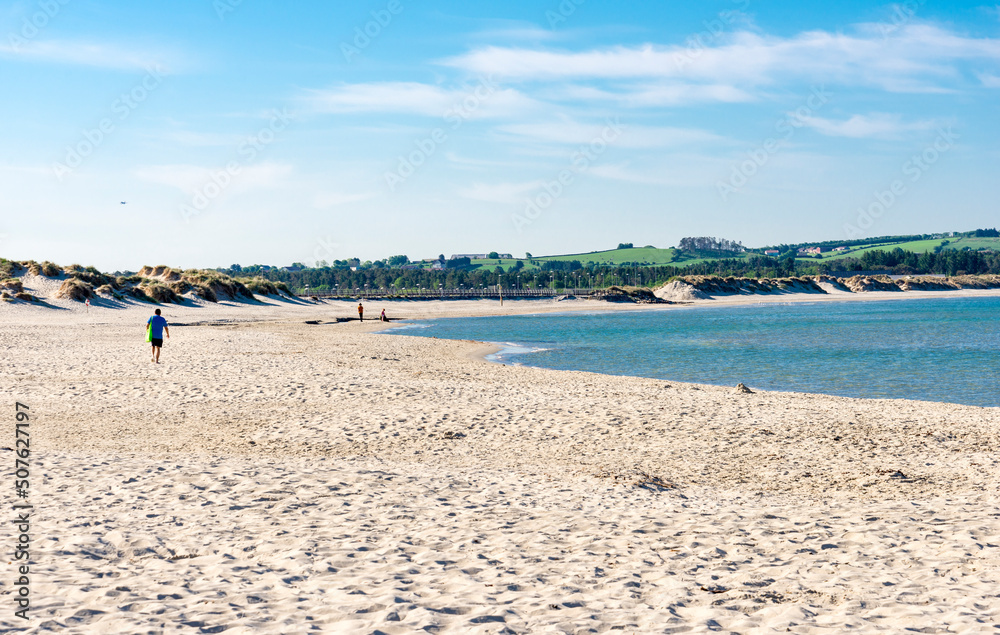 A few people on a long Sola beach waiting for an upcoming summer season, Stavanger, Norway, May 2018